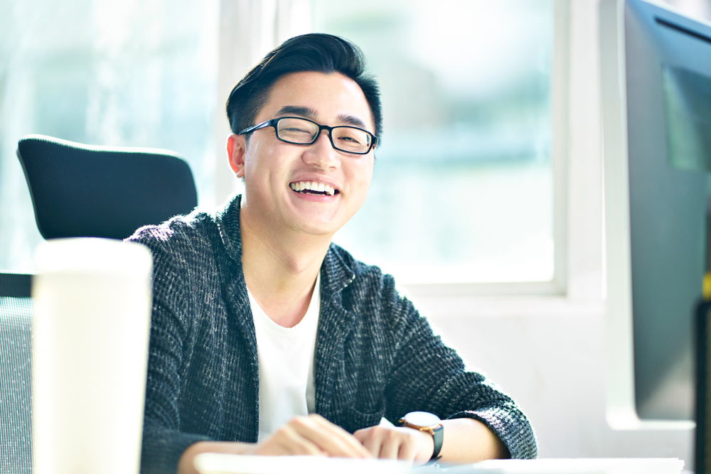 Portrait,Of,Successful,Asian,Business,Man,Working,In,Office,Looking